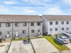 View of front facade with entry steps and roof with shingles - 