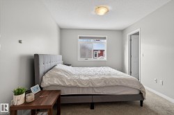 Bedroom featuring a textured ceiling and carpet flooring - 