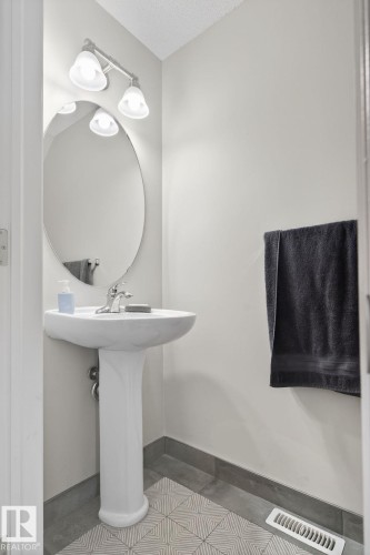 Bathroom with a textured ceiling and baseboards - 60 1804 70 Street, Edmonton, AB - Indoor Photo Showing Other Room