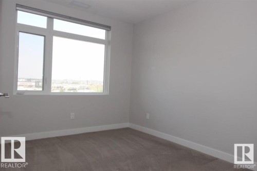 Spare room featuring light carpet and baseboards - 531 5151 Windermere Boulevard, Edmonton, AB - Indoor Photo Showing Other Room