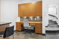 Home office featuring built in study area and stone tile flooring - 