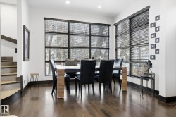 Dining room featuring healthy amount of natural light, dark wood finished floors, and stairs - 