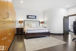 Bedroom with dark wood-type flooring, recessed lighting, and a desk - 