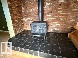 Detailed view of a wood stove and brick wall in the Family Room - 