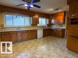 Kitchen with Oak cabinetry, Light Countertops, Ceiling Fan, - 
