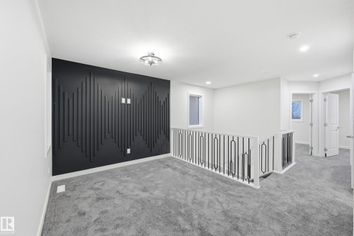 Carpeted empty room featuring baseboards and recessed lighting - 53 Patriot Way, Spruce Grove, AB - Indoor Photo Showing Other Room