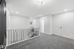 Hall featuring an upstairs landing, carpet floors, and recessed lighting - 