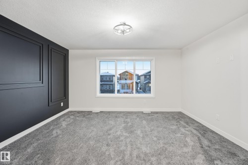 Carpeted spare room featuring baseboards and a textured ceiling - 53 Patriot Way, Spruce Grove, AB - Indoor Photo Showing Other Room