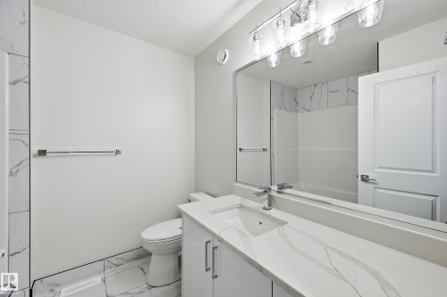 Full bath with light marble finish flooring, vanity, and a shower - 53 Patriot Way, Spruce Grove, AB - Indoor Photo Showing Bathroom