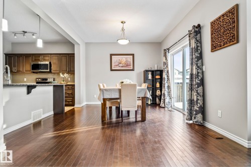 Dining room featuring dark wood finished floors and baseboards - 5734 175A Avenue, Edmonton, AB - Indoor