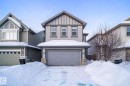 View of front of property featuring board and batten siding and an attached garage - 5734 175A Avenue, Edmonton, AB  - Outdoor With Facade 