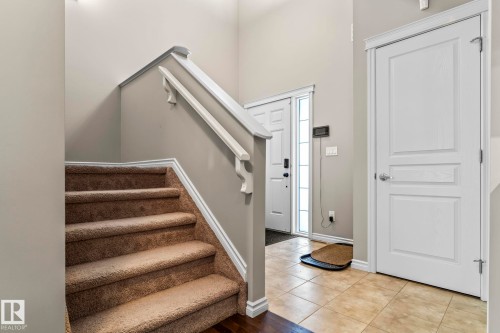 Foyer entrance featuring stairs and tile patterned floors - 5734 175A Avenue, Edmonton, AB - Indoor Photo Showing Other Room