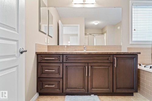 Full bathroom with vanity, a shower stall, a relaxing tiled tub, and light tile patterned floors - 5734 175A Avenue, Edmonton, AB - Indoor Photo Showing Bathroom