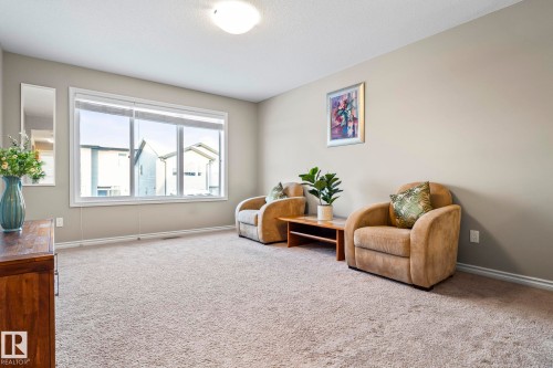 Sitting room with light colored carpet and baseboards - 5734 175A Avenue, Edmonton, AB - Indoor