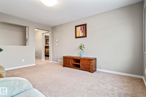 Living area with carpet flooring and baseboards - 5734 175A Avenue, Edmonton, AB - Indoor