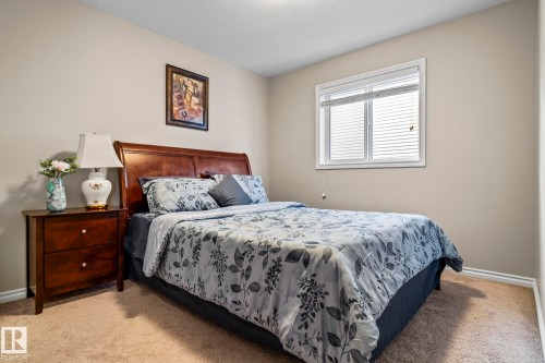 Carpeted bedroom with baseboards and a textured ceiling - 5734 175A Avenue, Edmonton, AB - Indoor Photo Showing Bedroom