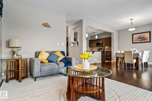 Living area featuring dark wood finished floors and baseboards - 5734 175A Avenue, Edmonton, AB - Indoor