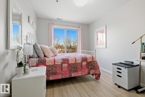 Bedroom featuring light wood-style flooring and baseboards - 314 530 Hooke Road, Edmonton, AB - Indoor Photo Showing Bedroom