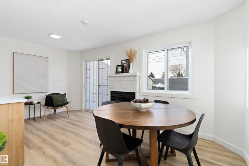 63 1033 Youville Drive W, Edmonton, AB - Indoor Photo Showing Dining Room With Fireplace