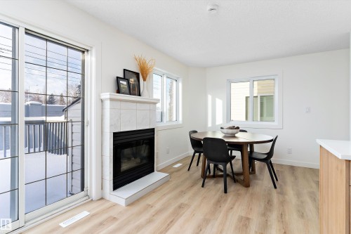 63 1033 Youville Drive W, Edmonton, AB - Indoor Photo Showing Dining Room With Fireplace