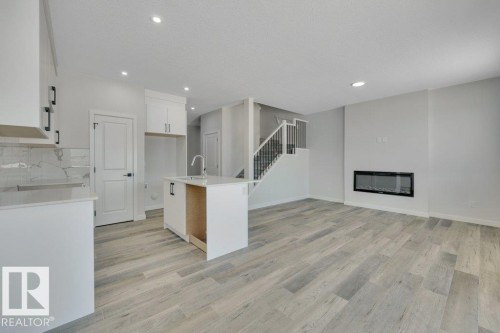 192 Munn Way, Leduc, AB - Indoor Photo Showing Kitchen With Fireplace