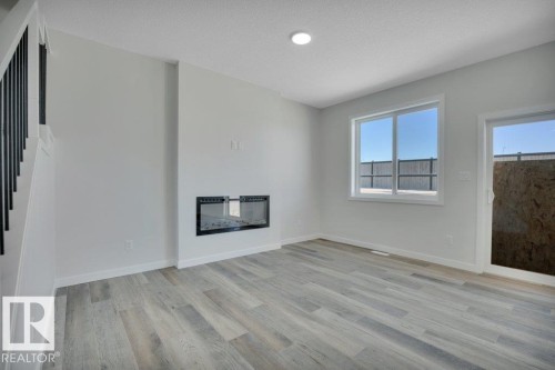 192 Munn Way, Leduc, AB - Indoor Photo Showing Other Room With Fireplace