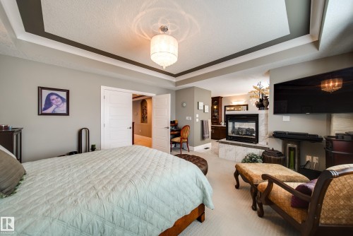 5410 Mcluhan End End, Edmonton, AB - Indoor Photo Showing Bedroom With Fireplace