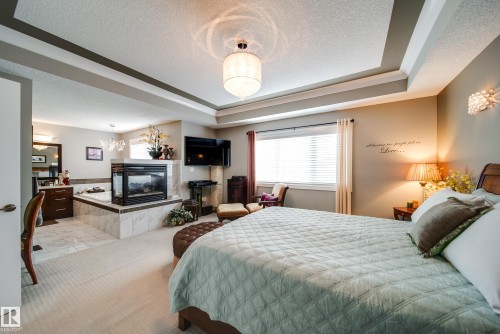 5410 Mcluhan End End, Edmonton, AB - Indoor Photo Showing Bedroom With Fireplace