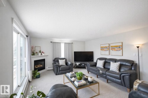 #226 10511 42 Avenue, Edmonton, AB - Indoor Photo Showing Living Room With Fireplace