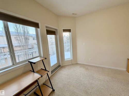 Unfurnished room with light colored carpet and baseboards - 321 4304 139 Avenue, Edmonton, AB - Indoor Photo Showing Other Room