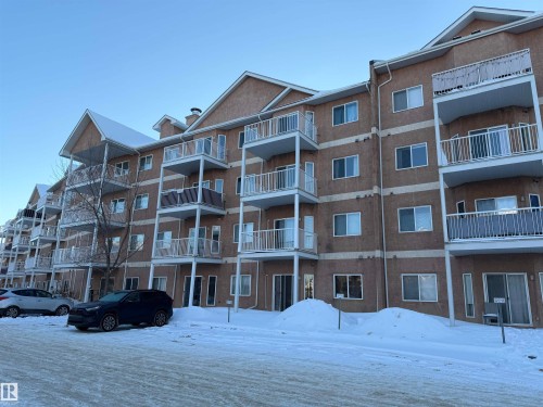 Snow covered building featuring a view of apartment building / complex - 321 4304 139 Avenue, Edmonton, AB - Outdoor With Balcony With Facade