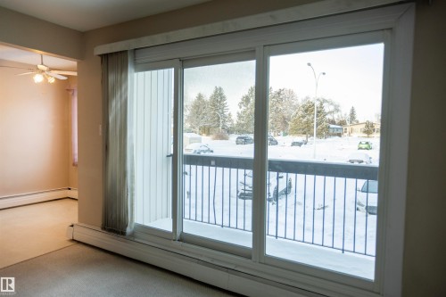 Entryway with baseboard heating and carpet floors - 207 11465 41 Avenue, Edmonton, AB - Indoor Photo Showing Other Room