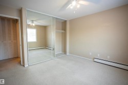 Unfurnished bedroom featuring a closet, carpet flooring, and a ceiling fan - 