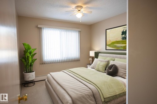 Bedroom with a ceiling fan and a textured ceiling - 207 11465 41 Avenue, Edmonton, AB - Indoor Photo Showing Bedroom