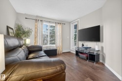Living room with hardwood / wood-style flooring and a textured ceiling - 