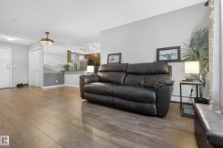 Living room featuring a baseboard heating unit and wood finished floors - 
