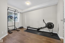 Workout area with a textured ceiling and wood finished floors - 