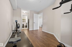 Exercise room featuring a textured ceiling and wood finished floors - 