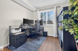 Office with dark wood finished floors and baseboard heating - 