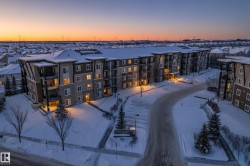 Snow covered property featuring a view of apartment building / complex - 