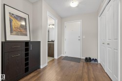 Foyer with dark wood-style floors and a textured ceiling - 