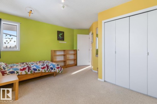 Bedroom with light colored carpet and a closet - 6508 109 Avenue, Edmonton, AB - Indoor Photo Showing Bedroom