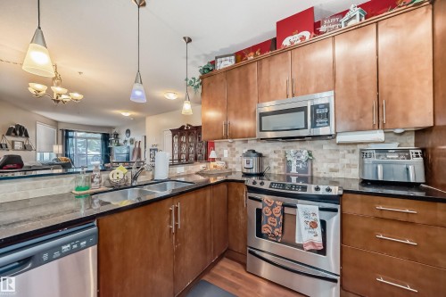 100 9940 Sherridon Drive, Fort Saskatchewan, AB - Indoor Photo Showing Kitchen With Stainless Steel Kitchen With Double Sink