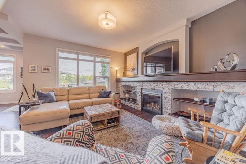 1019 Coopers Hawk Link Link, Edmonton, AB - Indoor Photo Showing Living Room With Fireplace