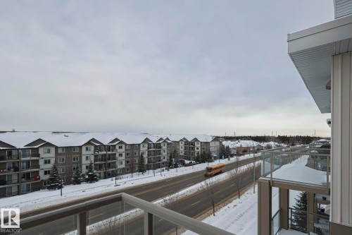 Snow covered back of property featuring a residential view - 407 812 Welsh Drive, Edmonton, AB - Outdoor