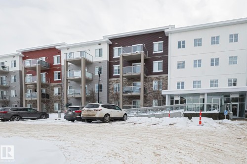 Snow covered building featuring a view of apartment building / complex - 407 812 Welsh Drive, Edmonton, AB - Outdoor With Facade