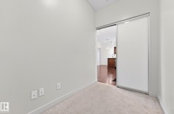 Unfurnished bedroom featuring light colored carpet and baseboards - 