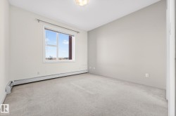 Spare room with baseboard heating and carpet floors - 