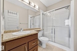 Bathroom featuring vanity, a stall shower, and light tile patterned floors - 