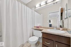 Full bathroom with vanity, light tile patterned floors, and shower / bath combo with shower curtain - 